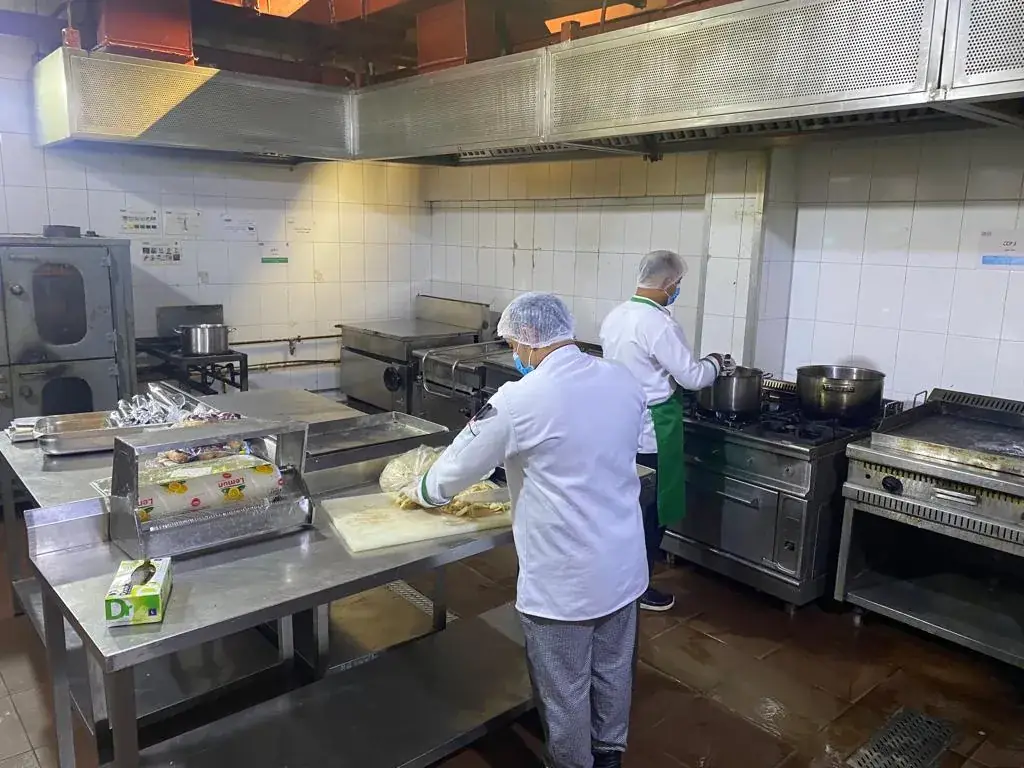 Kitchen team working at a commercial cooking line